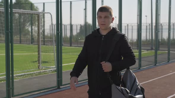 Man With Sport Bag Walking On Track