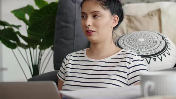 Young Asian woman having a video conversation using a laptop