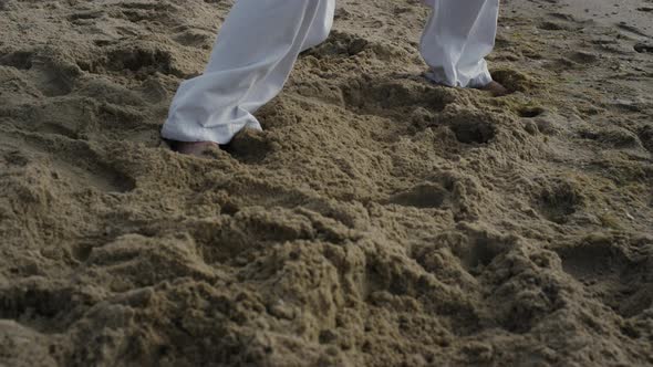 Bare Man Legs Standing Beach in Karate Pose Closeup