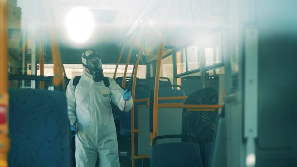 Bus Interior Is Getting Chemical Treatment From a Disinfection Worker. Covid-19 Coronavirus