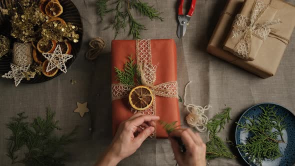 Female Hands Decorating Christmas Gift Box