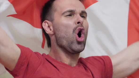 Canadian Fan Celebrating While Holding the Flag of Canada