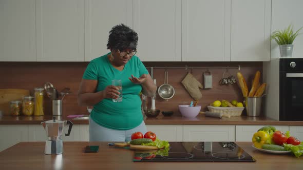 Sick Mature Black Woman Taking Pills in Kitchen