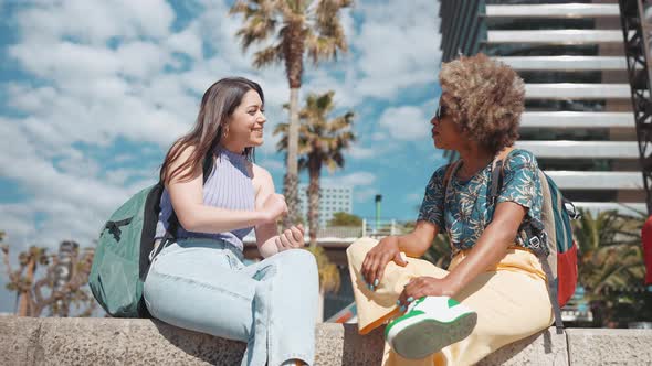 Pleased sunny woman talking with her girlfriend