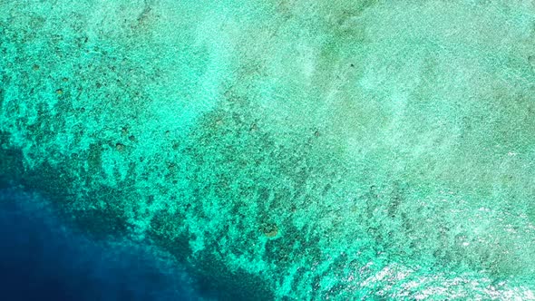 Tropical aerial abstract shot of a white sandy paradise beach and aqua blue water background in colourful