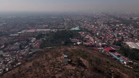 Flight over Basilica de Guadalupe in mexico city in a very polluted day