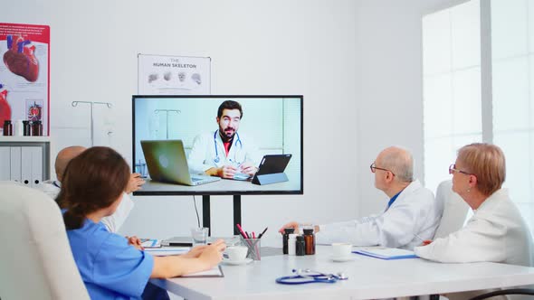 Medical Team Holding Online Conference in Boardroom