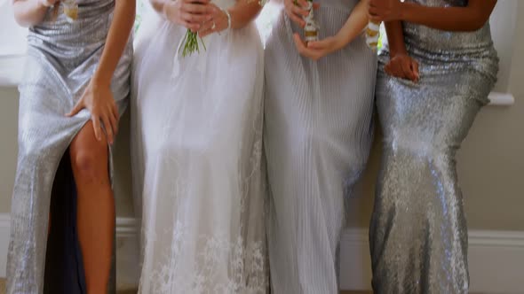 Bride with three bridesmaids laughing and holding flower bouquet 4K 4k