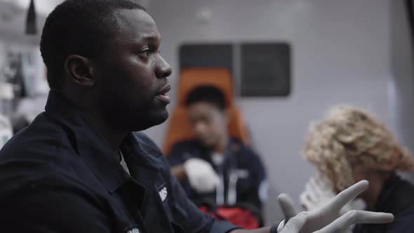 African American Paramedic Crossing in Ambulance on Way to Accident