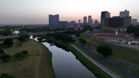 Fort Worth Texas skyline at dawn. Trinity River at sunrise. Aerial rising shot.