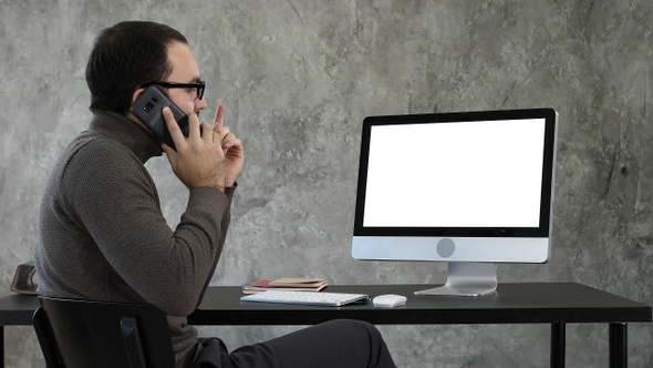 Male Designer Working At Computer In Contemporary Office.