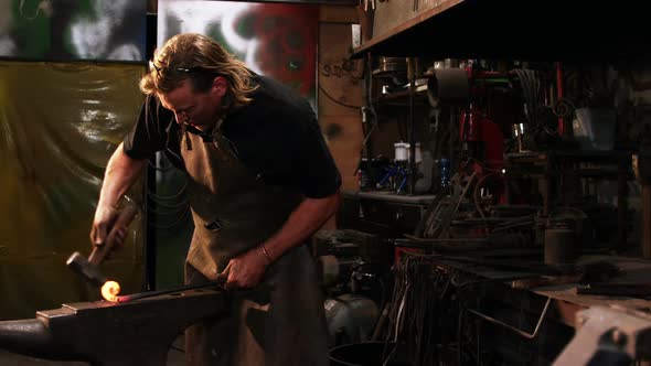 Blacksmith working on a iron rod