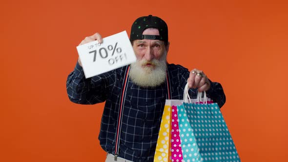 Elderly Bearded Man Showing Shopping Bags and Up To 70 Percent Off Inscriptions Text Black Friday