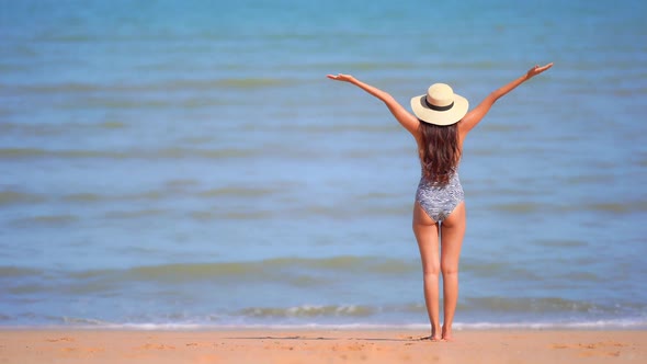 Asian woman enjoy around beautiful beach sea ocean