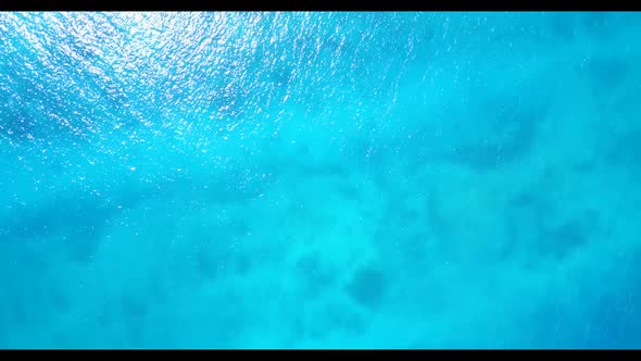 Aerial flying over texture of tropical coast beach lifestyle by blue green ocean with white sand bac