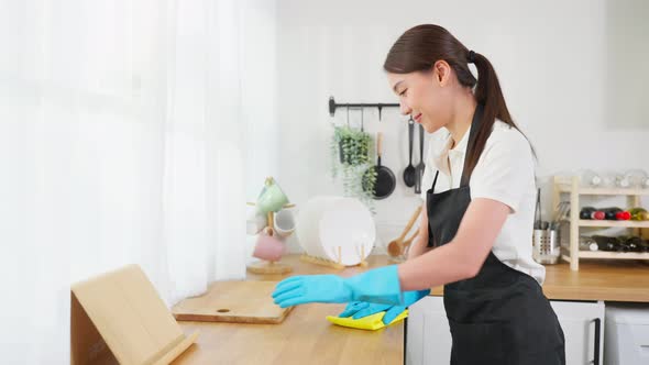 Close up hands of cleaning service woman worker clean kitchen at home.