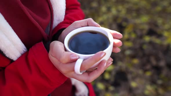 Close Up of Cup of Coffee in Woman's Hands