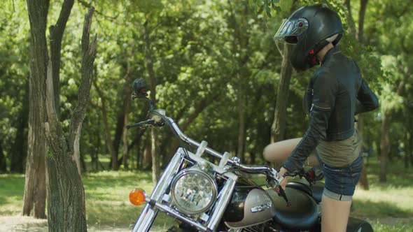 Stylish Woman Biker Ready for Ride on Motorcycle