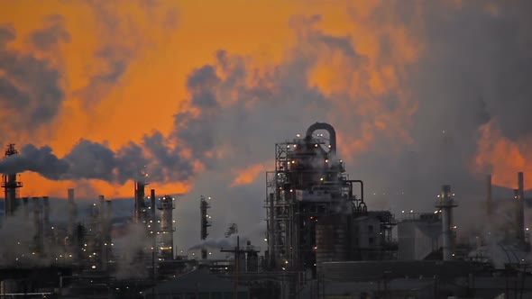 Smokey sky above a factory.