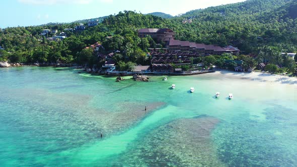 Beautiful sea lagoon with coral reefs under calm clear water washing white sandy beach in front of l