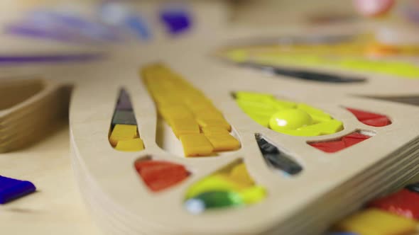 Male Hands Create Mosaics with Tweezers and Bright Little Pieces of Glass and Ceramics