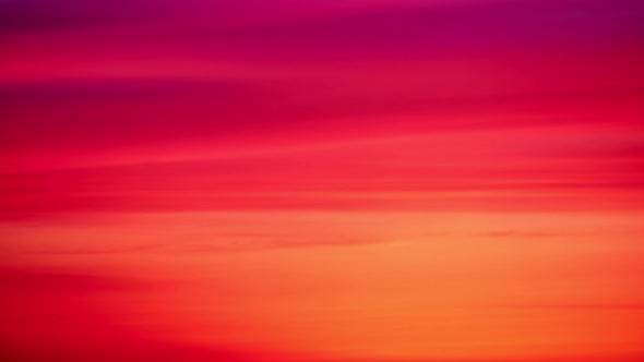 Evening red clouds in the sunset sky. Nature in colors from blue-purple to yellow-pink after sundown