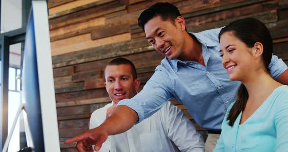 Business executives working over computer