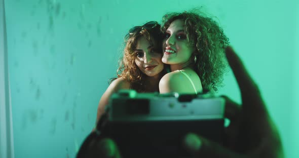 Two girls posing for a photo in confetti