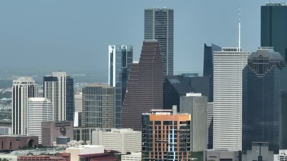 Downtown Texas city skyline. Aerial pan, long zoom.