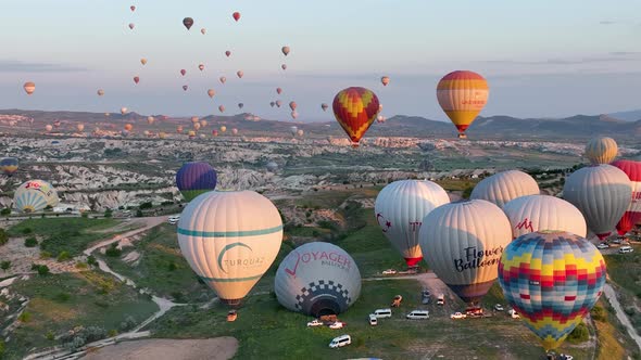 4K Aerial view of Goreme. Colorful hot air balloons fly over the valleys.