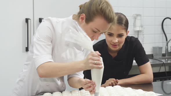 Gorgeous Female Pastry Baker Watching Her Colleague Making Marshmallows