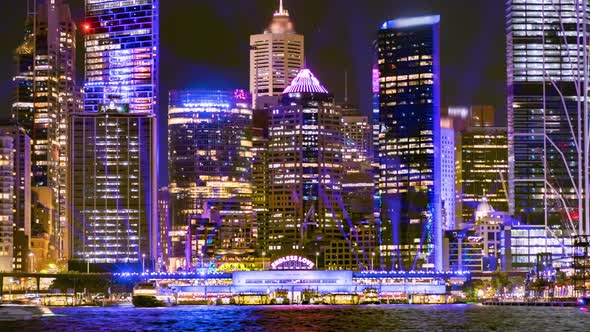 Close time lapse of Circular Quay Wharf during Vivid Festival 2022 while many boats pass Sydney, Aus