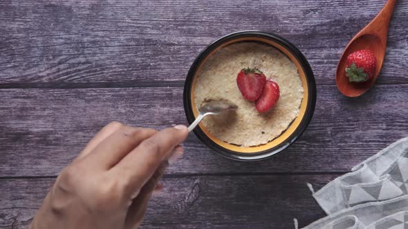 Oats Flakes and Strawberry on Wooden Table