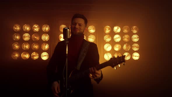 Musician Man Performing Solo on Electric Guitar Indoors