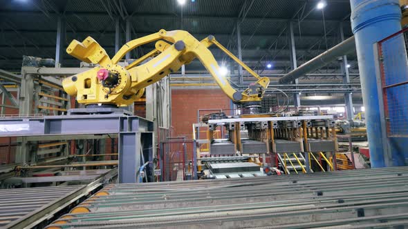 Factory Arm Moves Bricks From a Conveyor.