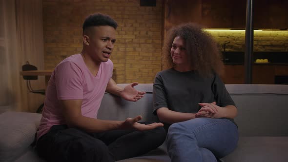 Young Multiethnic Family Quarreling Sitting on Sofa