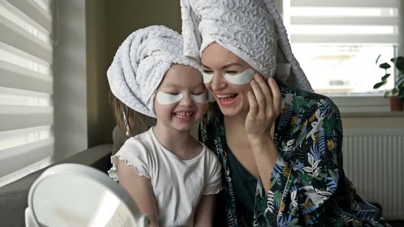 Young Woman and Her Little Daughter Are Doing Beauty Treatments After a Shower