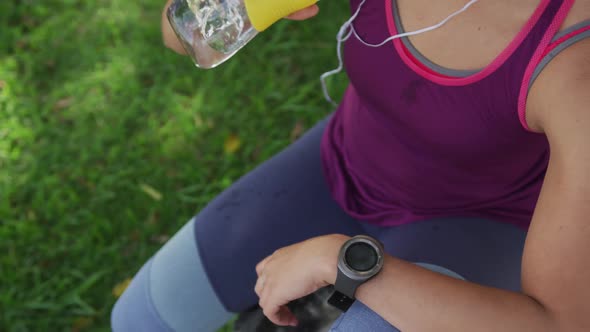 Caucasian woman drinking water in a park