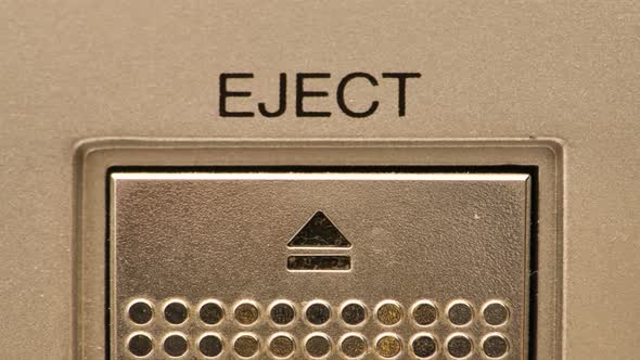 Extreme close up of buttons on an old antique or vintage VCR pushing the eject button