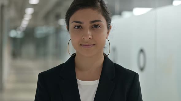 Portrait of Serious Young Indian Businesswoman Looking at Camera