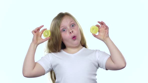 Children Closes Her Eyes with a Lemon and Shows Different Emotions, Licks It and Croaks. White