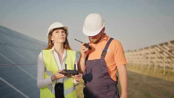 Technician and Investor Using Infrared Drone Technology to Inspect Solar Panels