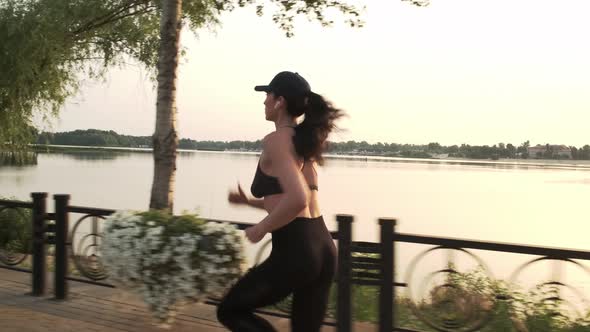 Fit Young Woman Running in Sunny Park Sprinting Fast Exercising Cardio Workout Training Focused