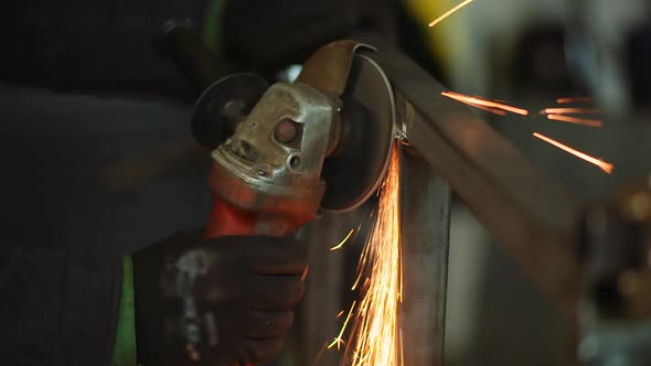 Angle Grinder Cutting Metal at Workshop