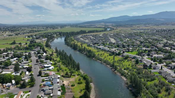 Wide aerial view of the Spokane Valley with the Spokane River cutting through the middle of it.