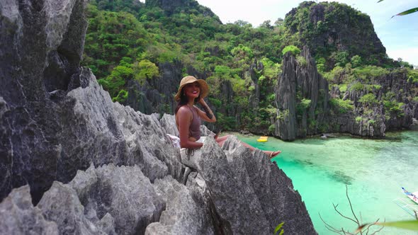 Woman Sunhat Smiling On Rocks Above Hidden Beach