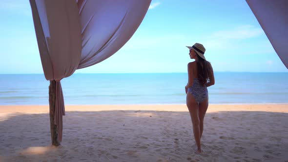 Asian woman enjoy around beautiful beach sea ocean