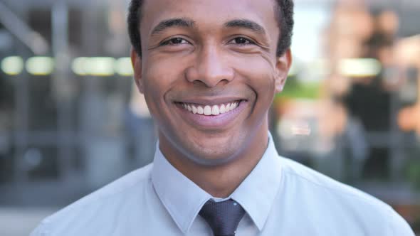 Outdoor Close up of Smiling African Businessman