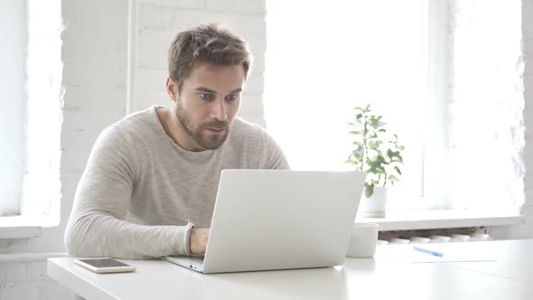 Beard Man in Shock While Working on Laptop Astonished