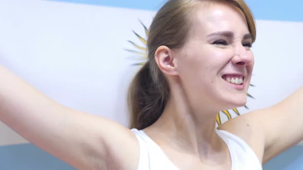 Argentinian Young Woman Celebrates Holding the Flag of Argentina